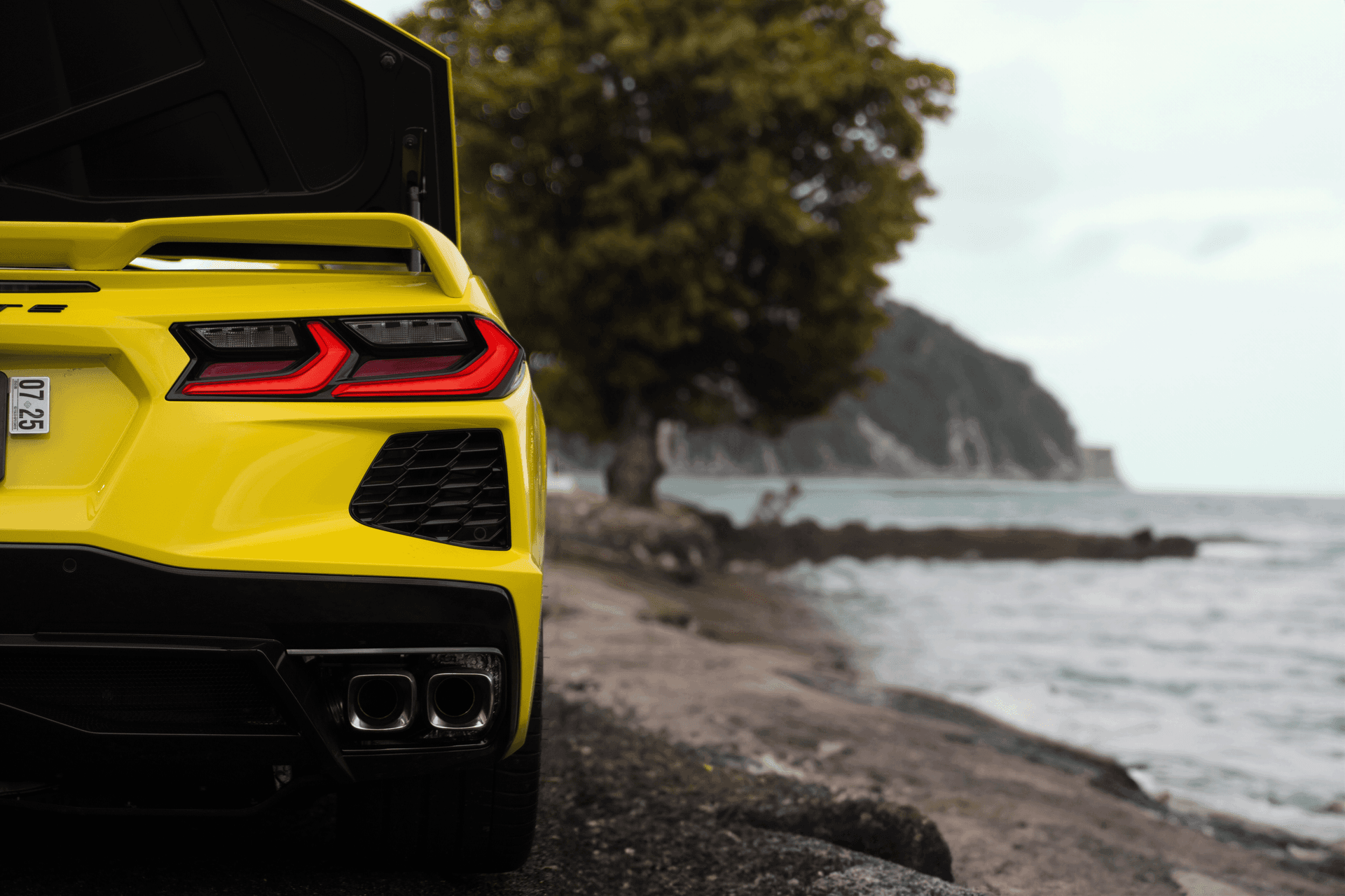 Picture of the car https://harrishawaiiphotos.s3.us-west-2.amazonaws.com/yellowcorvette/20rear+ai+beach.png