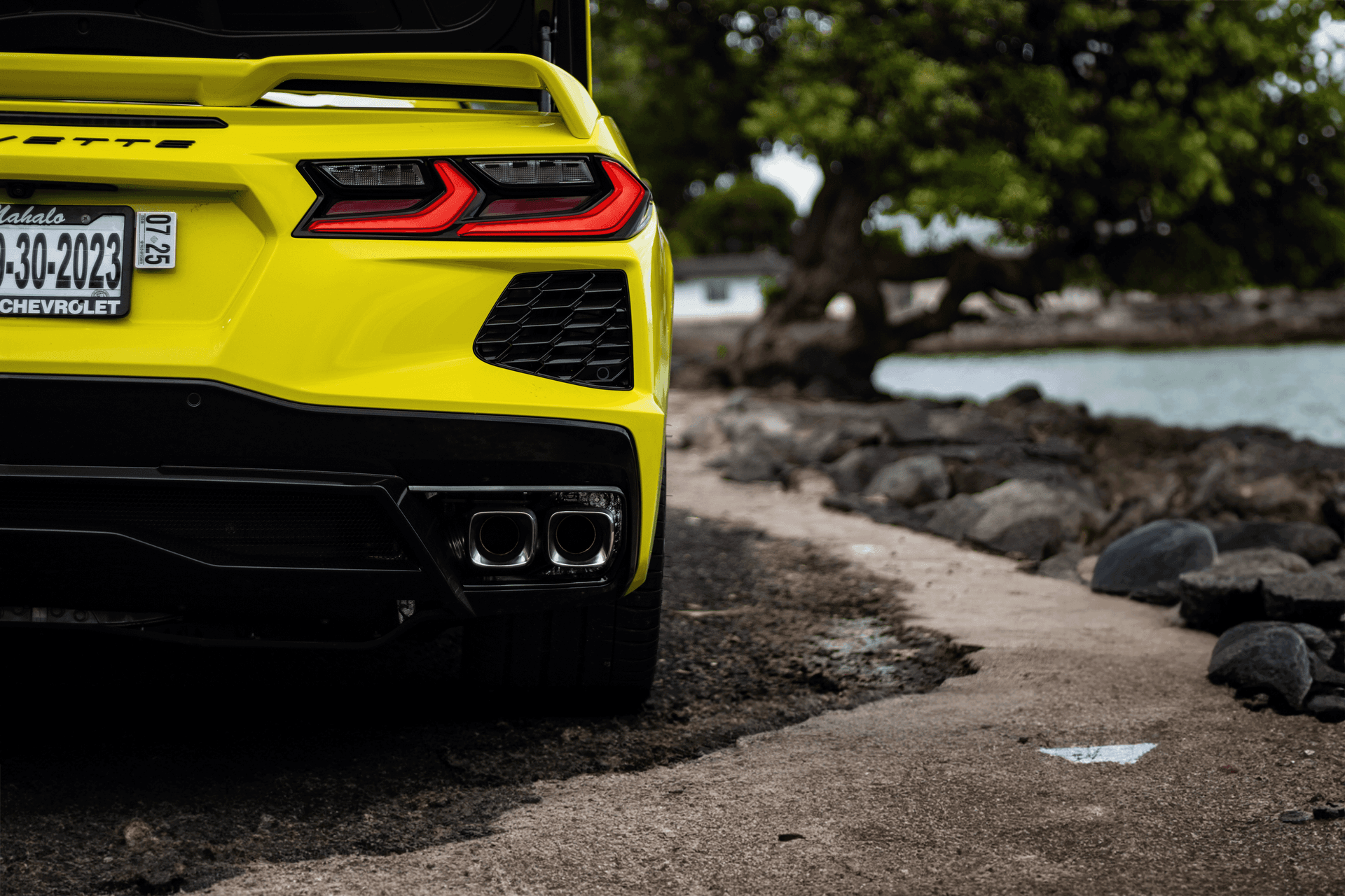 Picture of the car https://harrishawaiiphotos.s3.us-west-2.amazonaws.com/yellowcorvette/9corvette+rear+exhaust+beach.png